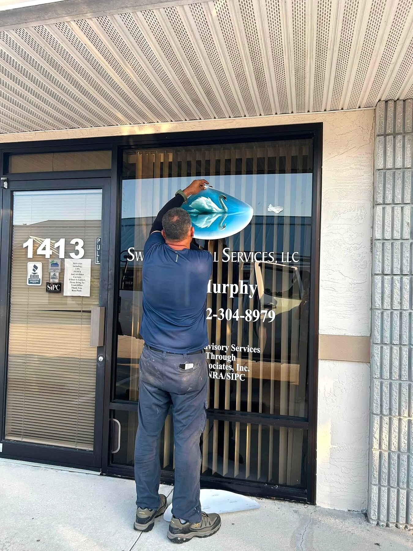 Installer applying a large window decal