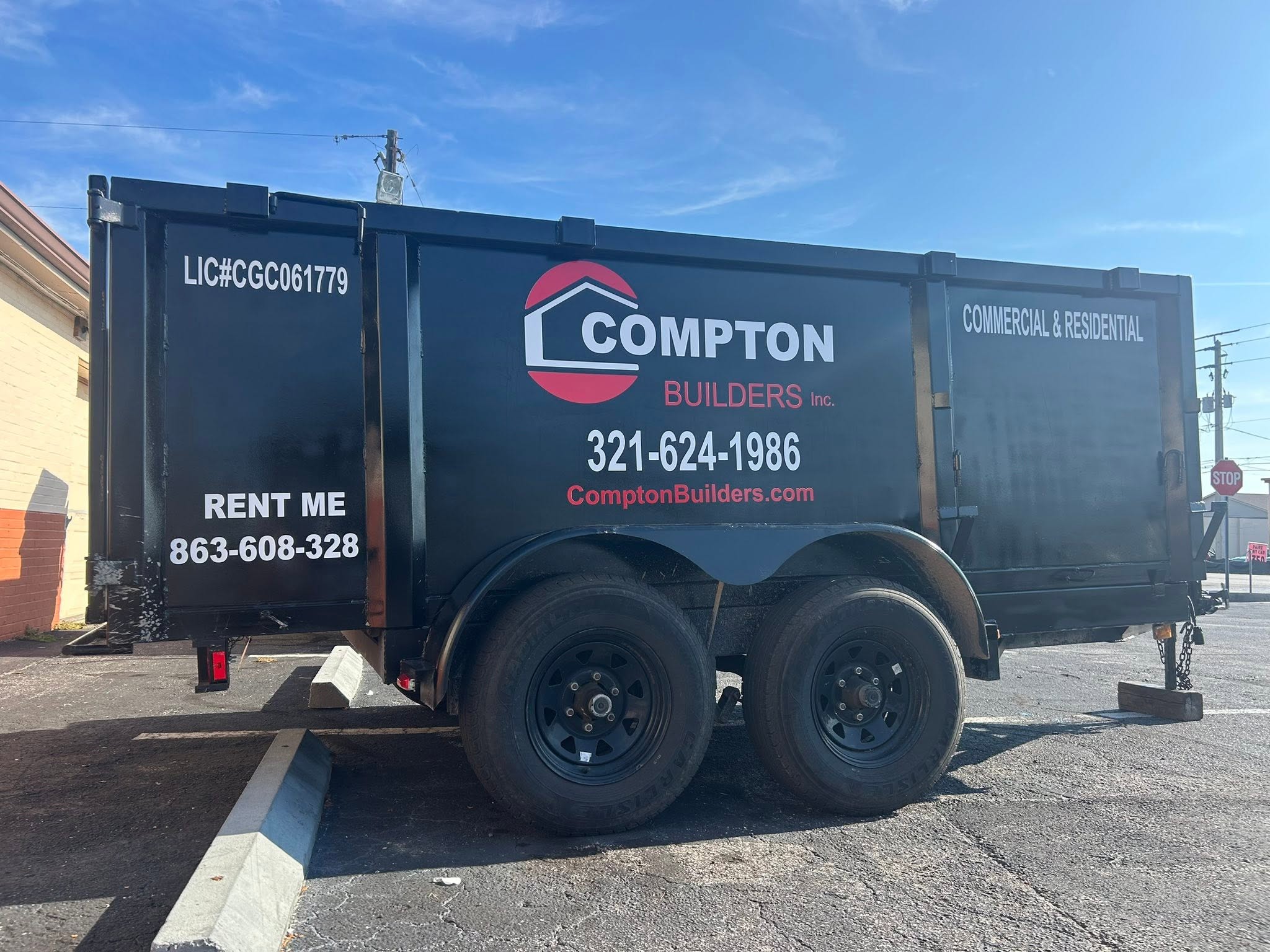 Complete Compton Builders dump trailer with graphics